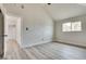 Bright bedroom with vaulted ceilings, wood-look flooring, and a window to let in natural light at 1400 Cottonwood Pl, Las Vegas, NV 89104