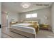 Virtually staged primary bedroom with a large bed, gold accents, and lots of natural light at 1400 Cottonwood Pl, Las Vegas, NV 89104