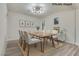 Bright dining room with modern lighting, wood table, decor, and light wood flooring at 1400 Cottonwood Pl, Las Vegas, NV 89104