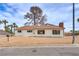 Charming one-story home features a brick chimney, large windows and a xeriscaped front yard at 1400 Cottonwood Pl, Las Vegas, NV 89104