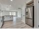 Bright kitchen featuring stainless steel refrigerator, modern cabinets and hardwood floors at 1400 Cottonwood Pl, Las Vegas, NV 89104