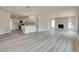 Spacious open-concept living area with fireplace, wood-look floors, and a modern kitchen at 1400 Cottonwood Pl, Las Vegas, NV 89104