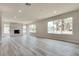 Spacious living room features sleek flooring, a modern fireplace, and plenty of natural light from multiple windows at 1400 Cottonwood Pl, Las Vegas, NV 89104