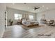 Virtually staged main bedroom features wood look floors, recessed lighting, and ceiling fan at 1400 Cottonwood Pl, Las Vegas, NV 89104