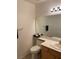 Bathroom features a toilet, a vanity with sink, a large mirror, and towel bars for convenience at 2260 Rugged Mesa Dr, Laughlin, NV 89029
