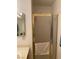 Bathroom showing a shower stall with framed glass door and towel rack, with vanity visible in mirror at 2260 Rugged Mesa Dr, Laughlin, NV 89029