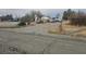 A gravel lot with several parked vehicles, mobile homes, and a mailbox, with an overcast sky at 2341 Shady Ln, Pahrump, NV 89060