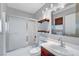 Modern bathroom with shower-tub combo, sleek fixtures, and vanity at 2649 Heathrow St, Las Vegas, NV 89135