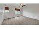 Large bedroom with a ceiling fan, carpet, and natural light at 2649 Heathrow St, Las Vegas, NV 89135
