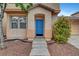Inviting front entrance with a bright blue door and well-manicured landscaping at 2649 Heathrow St, Las Vegas, NV 89135