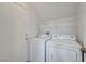Bright laundry room features washer, dryer, and storage shelves at 2649 Heathrow St, Las Vegas, NV 89135
