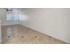 Bright open concept space with tile floors, kitchen view, and a ceiling fan at 2649 Heathrow St, Las Vegas, NV 89135
