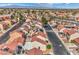 Wide aerial shot displaying closely-knit residential homes and streets in a suburban community against a mountain backdrop at 2727 Scotch Heather St, Las Vegas, NV 89142