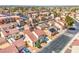 This aerial view showcases a community of homes with red-tiled roofs, tidy streets, and mature landscaping at 2727 Scotch Heather St, Las Vegas, NV 89142