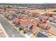 A neighborhood of red-roofed homes with solar panels dots the landscape, offering sustainable living at 2727 Scotch Heather St, Las Vegas, NV 89142