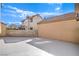 The backyard has a spacious concrete patio and is enclosed by a block wall fence for privacy at 2727 Scotch Heather St, Las Vegas, NV 89142