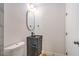 Well-lit bathroom featuring modern vanity, oval mirror, and updated fixtures at 2727 Scotch Heather St, Las Vegas, NV 89142