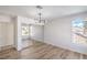 Bedroom with hardwood floors, natural lighting, and a large mirrored closet at 2727 Scotch Heather St, Las Vegas, NV 89142