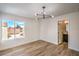 Bedroom showcasing hardwood floors, a modern light fixture and a large window at 2727 Scotch Heather St, Las Vegas, NV 89142