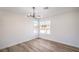 Bedroom featuring hardwood floors, modern light fixture and natural lighting at 2727 Scotch Heather St, Las Vegas, NV 89142