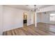 Bedroom featuring hardwood floors, modern light fixture and mirror closet doors at 2727 Scotch Heather St, Las Vegas, NV 89142