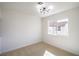 Bedroom showcasing carpet flooring, modern light fixture and a large window at 2727 Scotch Heather St, Las Vegas, NV 89142