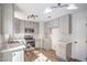 Bright kitchen featuring stainless steel appliances, white countertops, and stylish wood-look flooring at 2727 Scotch Heather St, Las Vegas, NV 89142