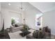 Open-concept living area with contemporary furnishings and vaulted ceiling at 2727 Scotch Heather St, Las Vegas, NV 89142