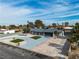 Panoramic aerial view of a renovated home in a serene neighborhood, showcasing its spacious driveway at 2749 Horseshoe Dr, Las Vegas, NV 89120