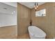 Bathroom featuring a soaking tub, modern fixtures, and a view to the living area at 2749 Horseshoe Dr, Las Vegas, NV 89120