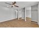 Bright bedroom with a ceiling fan, mirrored closet doors, and light hardwood floors at 2749 Horseshoe Dr, Las Vegas, NV 89120