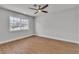 Bedroom featuring a ceiling fan, a large window for natural light, and neutral walls, and wood-look flooring at 2749 Horseshoe Dr, Las Vegas, NV 89120