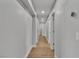 Bright hallway featuring recessed lighting, leading to various rooms with doors, and wood-look flooring at 2749 Horseshoe Dr, Las Vegas, NV 89120