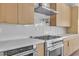 Close-up of the kitchen with stainless steel oven, gas range, and modern vent hood at 2749 Horseshoe Dr, Las Vegas, NV 89120