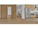 Open-concept living space with sleek appliances, wood flooring, and stylish wood slat wall accent at 2749 Horseshoe Dr, Las Vegas, NV 89120