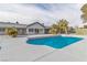 Beautiful blue swimming pool surrounded by a concrete deck, and desert landscaping, in a private backyard at 2749 Horseshoe Dr, Las Vegas, NV 89120