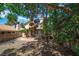 Large backyard with gravel, brick patio, mature trees offers a tranquil retreat with a hot tub at 2819 Prickley Pear Dr, Henderson, NV 89074