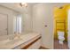 Bathroom featuring a single sink vanity with ample counter space, and toilet visible through doorway at 2819 Prickley Pear Dr, Henderson, NV 89074