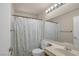Bathroom with a tropical leaf shower curtain, single sink vanity, and large mirror at 2819 Prickley Pear Dr, Henderson, NV 89074