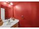 Stylish half bathroom featuring vibrant colors, a modern sink and faucet at 2819 Prickley Pear Dr, Henderson, NV 89074