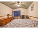 Bedroom with ceiling fan, wooden dresser, desk, and a patterned comforter at 2819 Prickley Pear Dr, Henderson, NV 89074