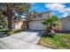 Charming two-story home with a well-kept lawn, mature trees, and a two-car garage at 2819 Prickley Pear Dr, Henderson, NV 89074