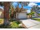 Inviting two-story home featuring a well-maintained lawn, mature trees, and a two-car garage at 2819 Prickley Pear Dr, Henderson, NV 89074
