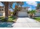 Desirable two-story home showcasing mature trees, a green lawn, and a convenient two-car garage at 2819 Prickley Pear Dr, Henderson, NV 89074