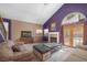 Open living room featuring tile floors, fireplace, vaulted ceilings, and a French door at 2819 Prickley Pear Dr, Henderson, NV 89074