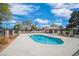 Community pool surrounded by a concrete deck and wrought iron fencing in a landscaped setting at 2819 Prickley Pear Dr, Henderson, NV 89074