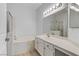 Bathroom features vanity, large mirror, and tub with separate shower at 2975 Bluegrass Ln # 811, Henderson, NV 89074