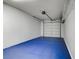 Garage featuring an automatic door, custom blue floor, and wire rack for extra storage at 2975 Bluegrass Ln # 811, Henderson, NV 89074