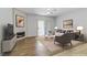Bright living room with modern fireplace, wood-look flooring, ceiling fan, and sliding glass door at 2975 Bluegrass Ln # 811, Henderson, NV 89074