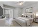 Calm main bedroom features neutral decor, tiled floors, ceiling fan, and sliding glass door to patio at 2975 Bluegrass Ln # 811, Henderson, NV 89074